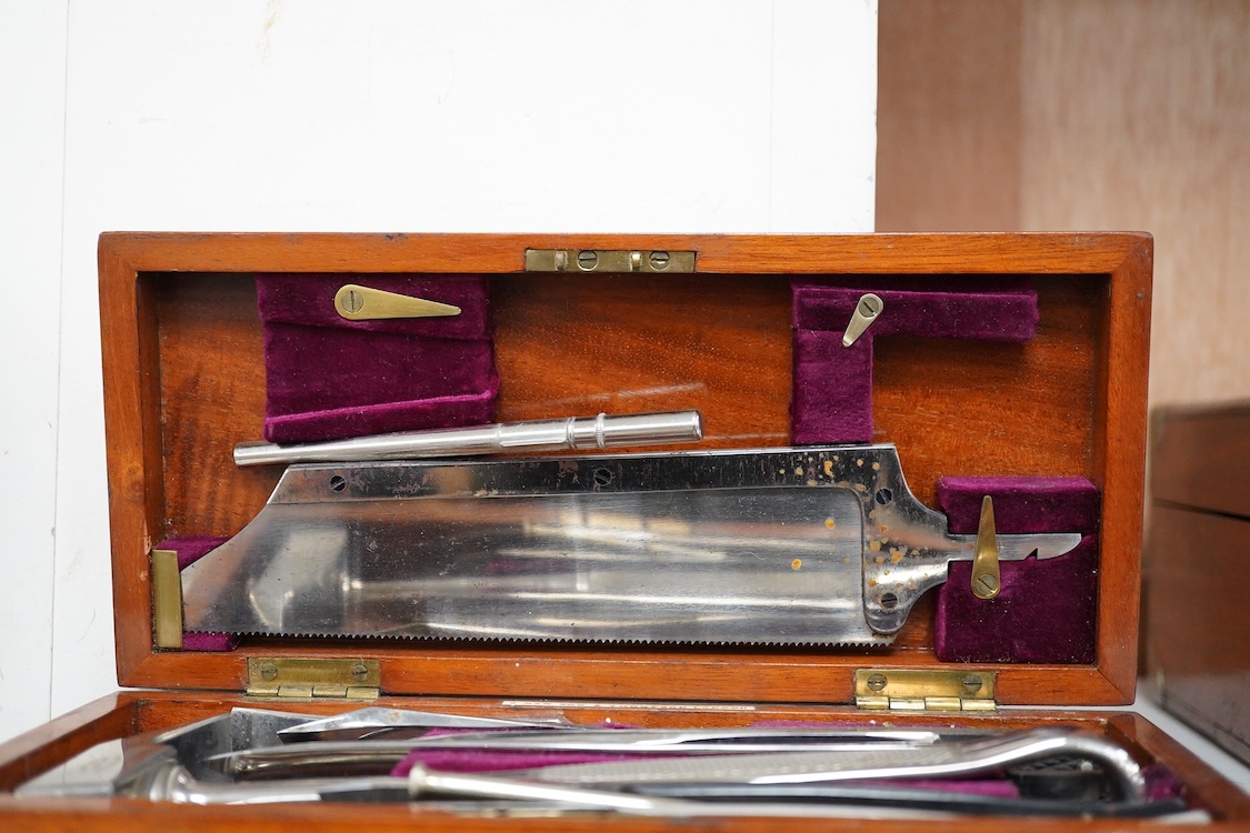 A 19th century mahogany cased surgeon’s set of steel surgical instruments by S. Maw Son & Thompson, London, comprising of an amputation saw, scalpel, a hammer, etc., dimensions of the case; 23.5cm wide, 10.5cm deep, 4cm